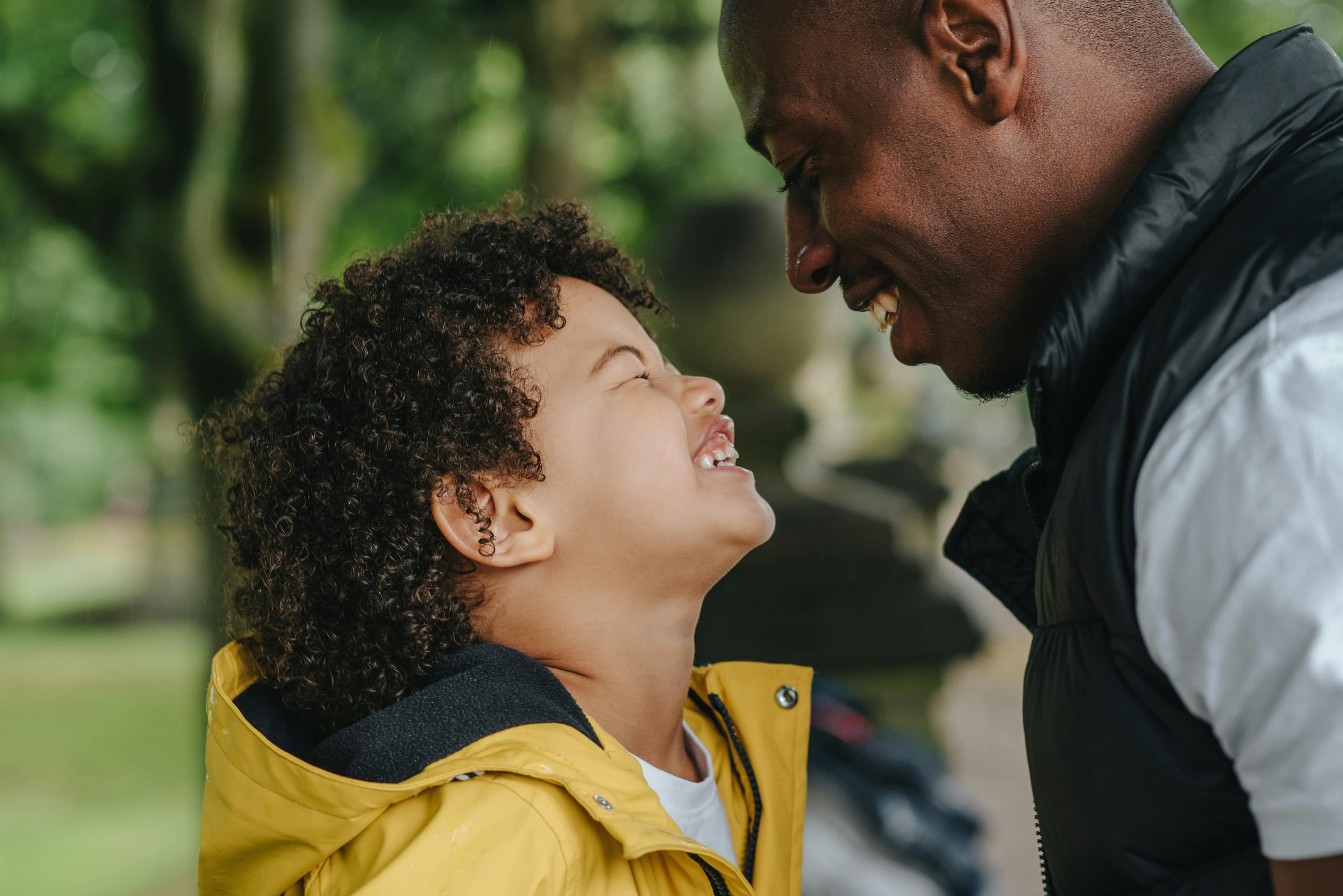 Man and child laughing yellow jacket