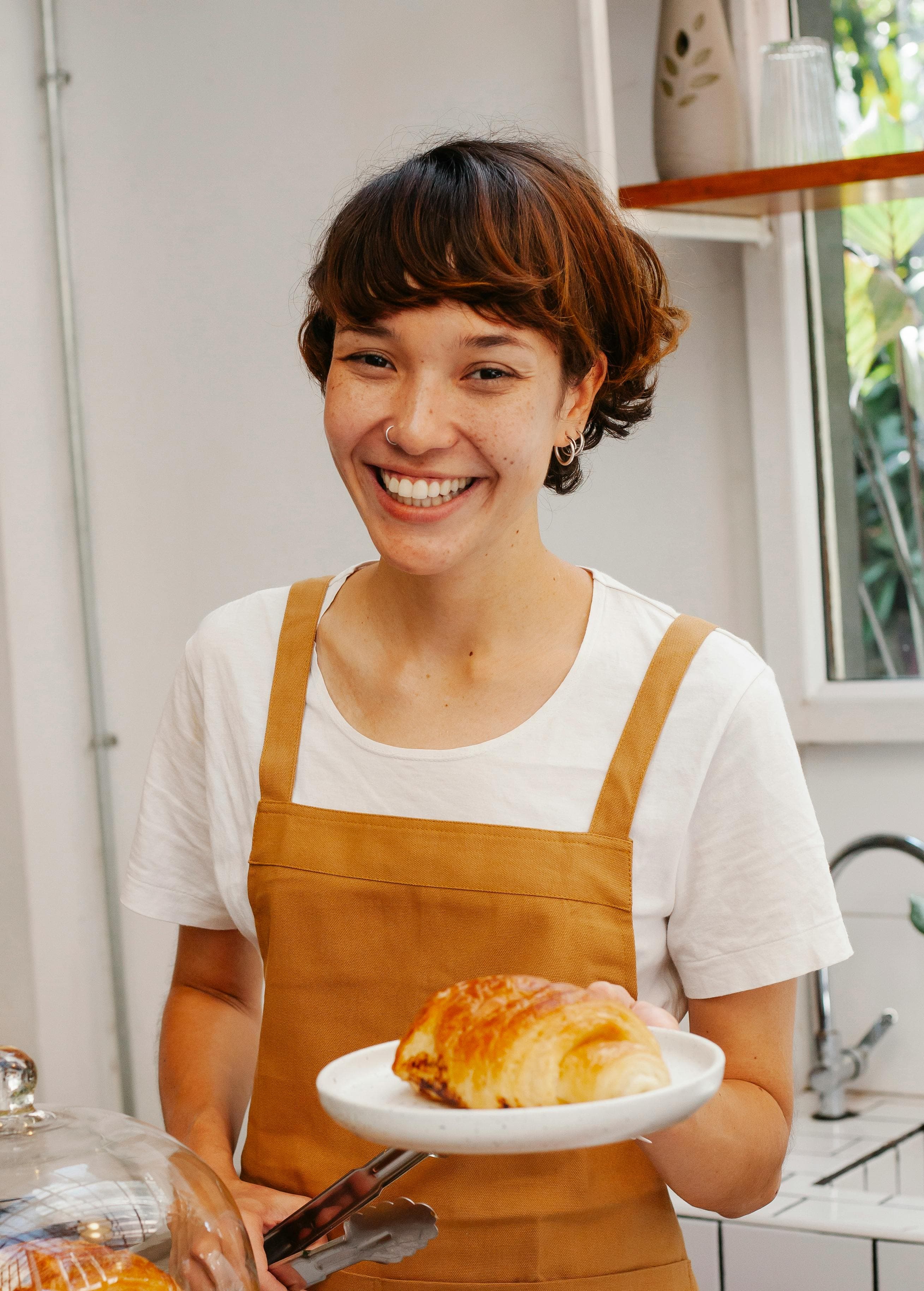 Woman holding plate laughing