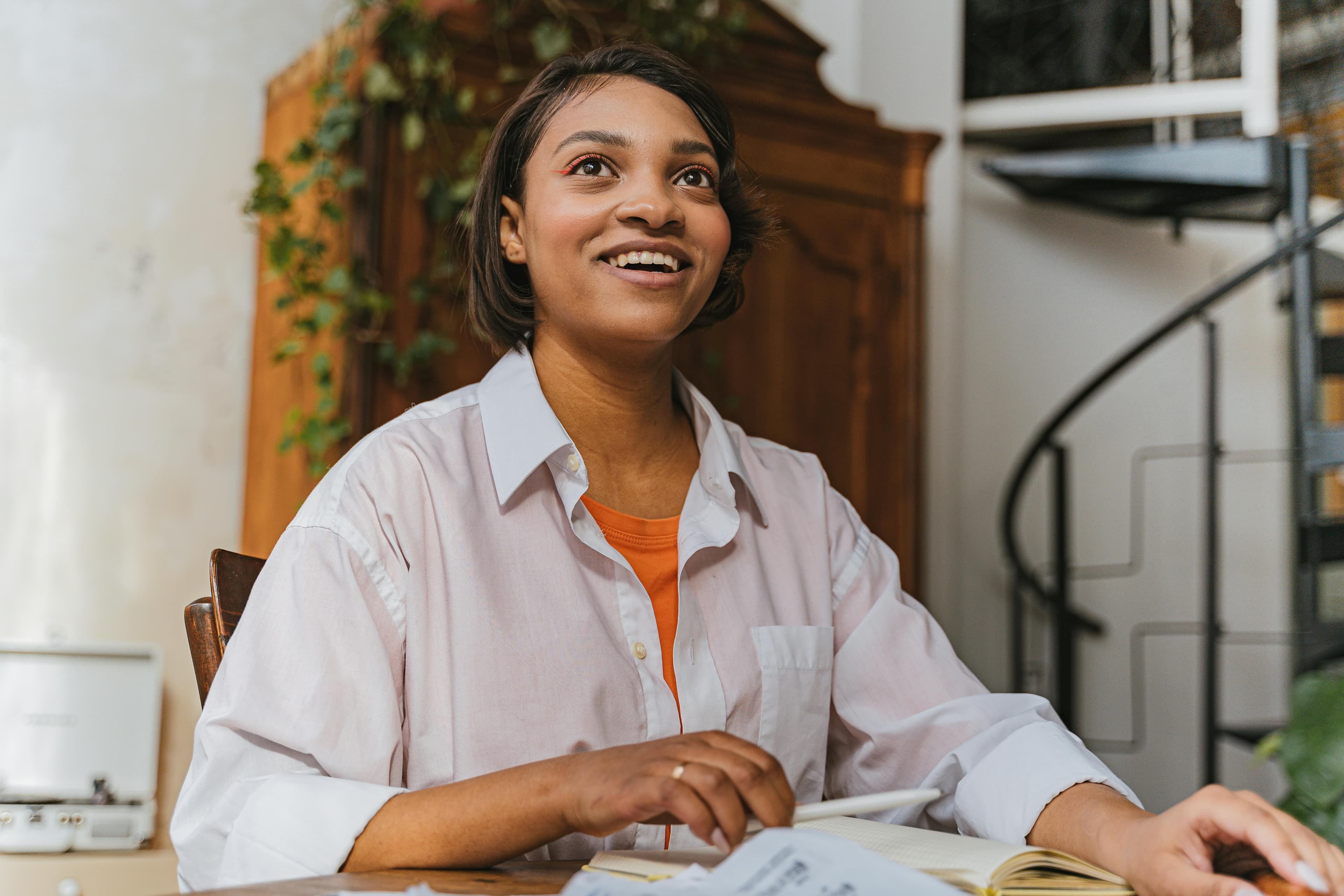 Woman sitting by desk bright eyes